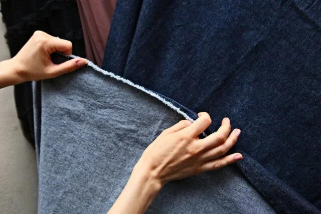 cotton lycra fabric being stretched by hands